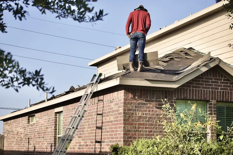 Professional roofer working on a residential roof in Rainbow